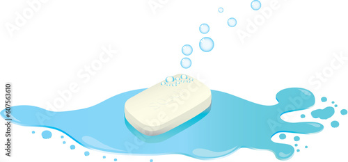A bar of soap with bubbles floating from it sat in a puddle of water