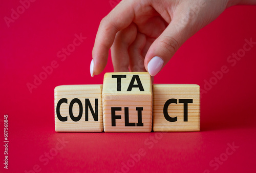 Contact and Conflict symbol. Businessman hand turns wooden cubes with words Contact and Conflict. Beautiful red background. Contact and Conflict and business concept. Copy space