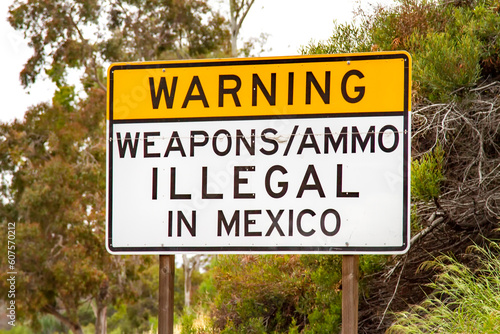 Sign on 5 freeway in San Diego warning that it is illegal to carry weapons or ammuntion into Mexico photo