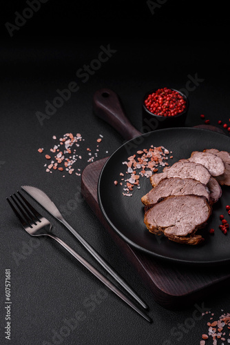 Delicious beef steak with salt, spices and herbs on a ceramic plate