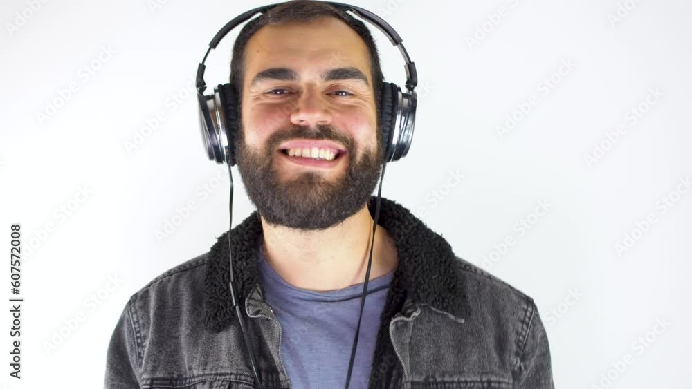young man using headphone while smiling isolated on white background young man using headphone while smiling isolated on white background