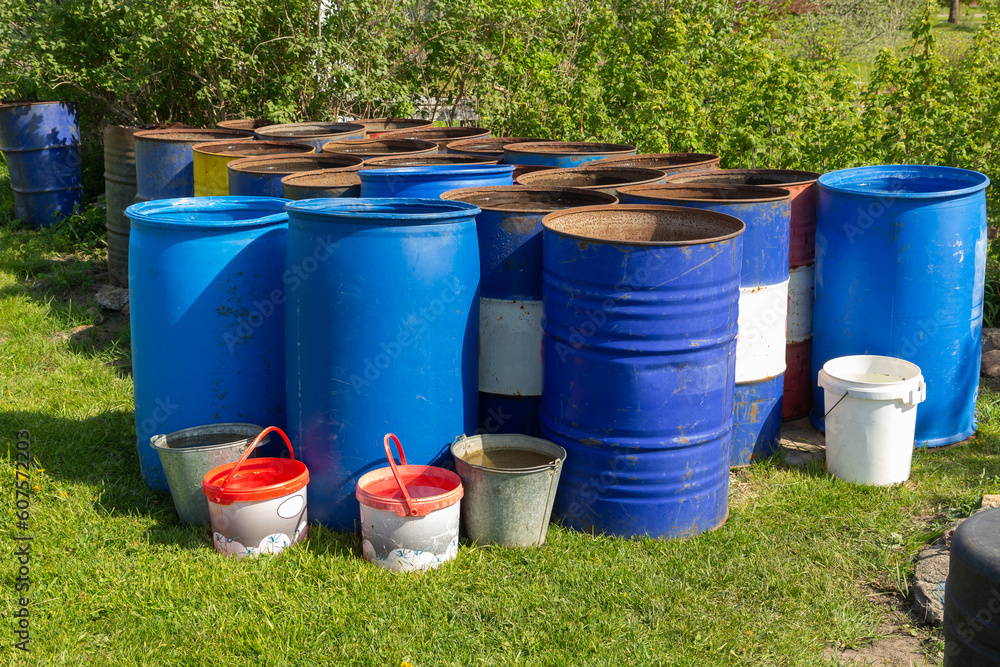 Metal water barrels for watering the garden. Metal water barrels for watering the garden.
