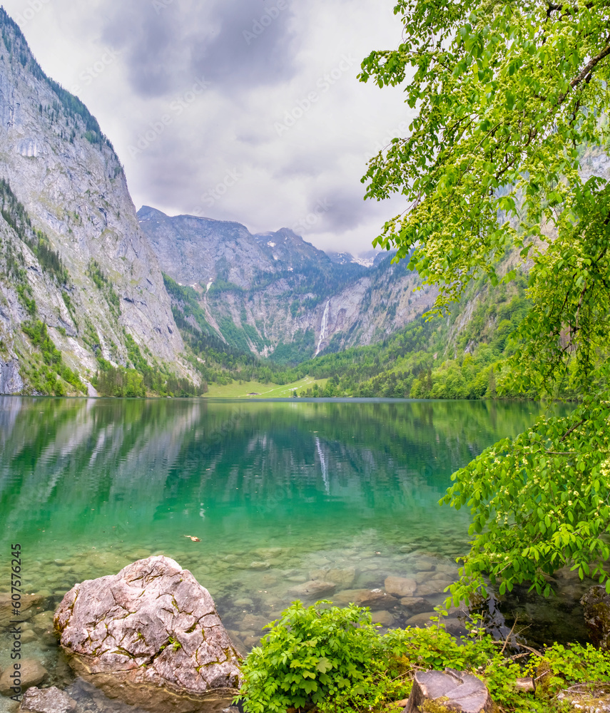 Green turquoise clear alpine lake Obersee Koenigssee surrounded by mountains Alps in Bavaria, Germany Green turquoise clear alpine lake Obersee Koenigssee surrounded by mountains Alps in Bavaria, Germany