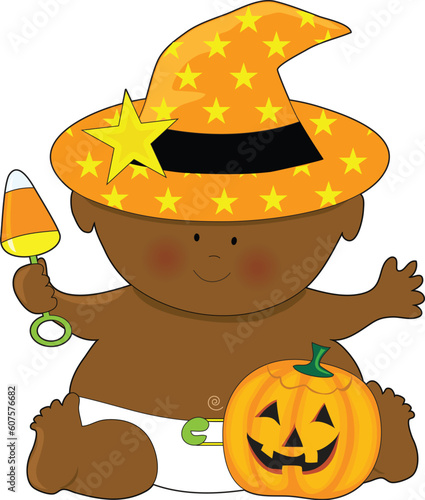 A baby dressed in a witch's hat with a pumpkin by it's foot