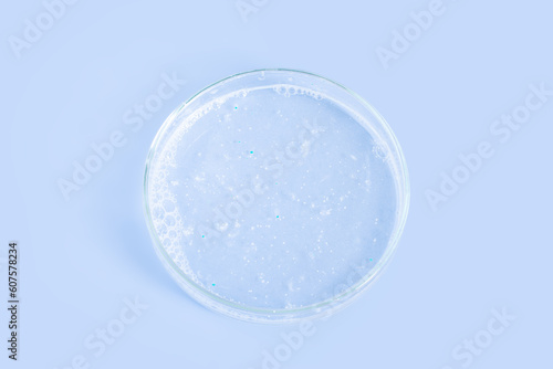 Facial Detergent in a Petri dish on a blue background. © MM