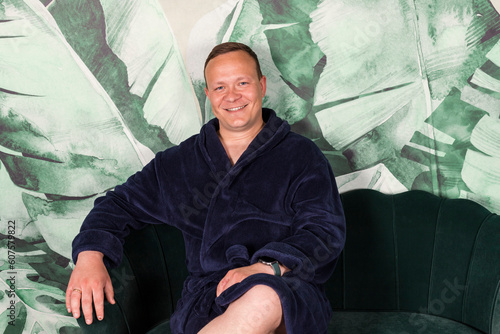 Portrait A homebody man in a bathrobe. A middle aged man relaxing after work on a couch