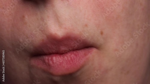 The girl is eating French fries. Eating fast food. lips and mouth eating fast food, Close up.  photo