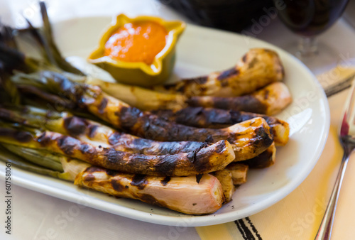 Traditional Catalan winter dish - Calcots onions with Romesco sauce photo