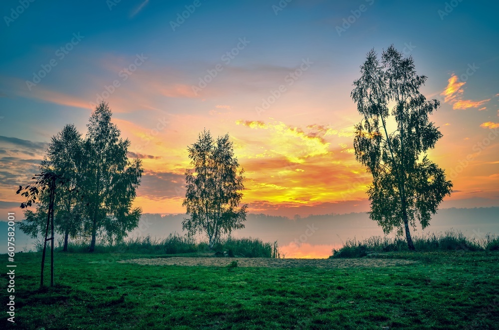 Foggy colorful morning on the lake. Sunrise over Lake Paproacany in Tychy, Poland.