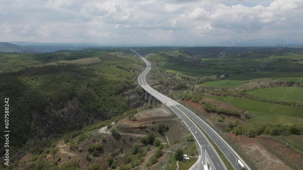 Aerial view of vehicles on the highway among the mountains in Taxiarchis, Western Macedonia, Greece. Aerial view of vehicles on the highway among the mountains in Taxiarchis, Western Macedonia, Greece.
