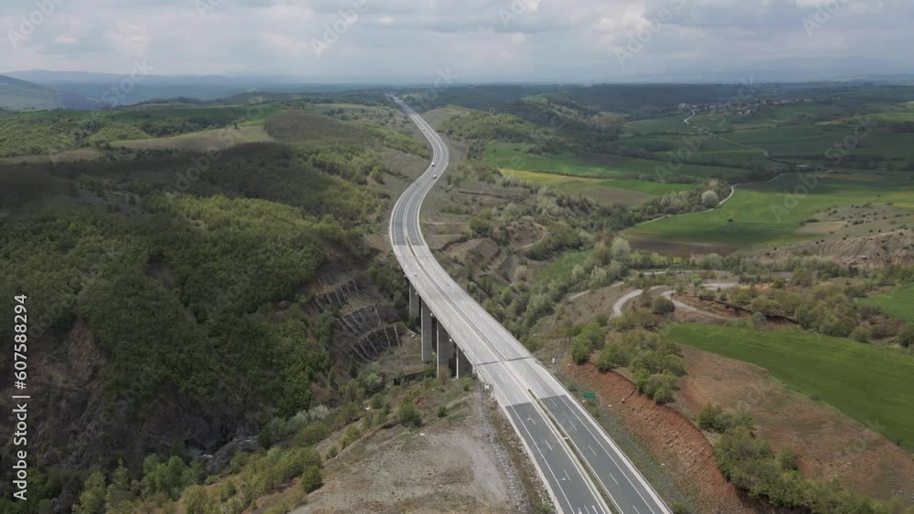 Aerial view of vehicles on the highway among the mountains in Taxiarchis, Western Macedonia, Greece. Aerial view of vehicles on the highway among the mountains in Taxiarchis, Western Macedonia, Greece.