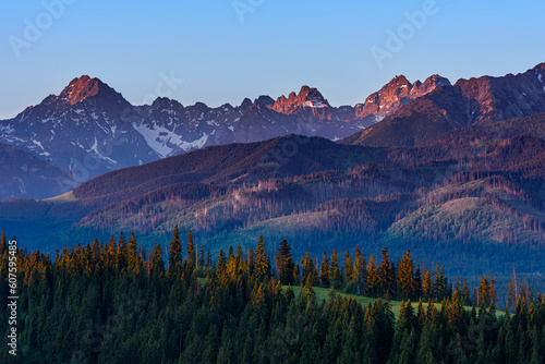 Mountain landscape. The first rays of the sun dawning on the tops of high mountains.