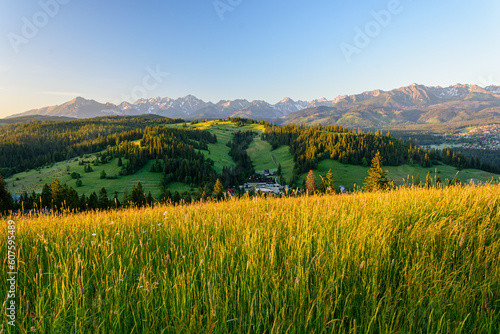 Mountain landscape. The low-lying sun in the morning illuminating the slopes of hills and the tops of high mountains.