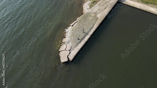 Aerial view of a woman taking photos along Volvi Lake coast in Mikri Volvi town, Central Macedonia, Greece. photo