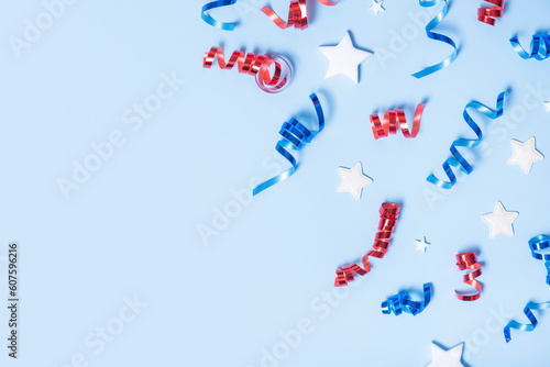 USA Independence day concept. Red and blue spirals and white stars elements of USA flag top view, flat lay on blue background with copy space