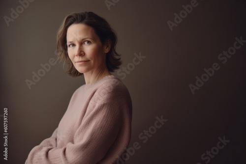 Portrait of a beautiful middle-aged woman in a pink sweater © Robert MEYNER