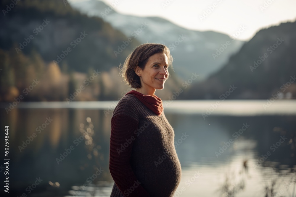 Beautiful pregnant woman on the background of a lake in the mountains Beautiful pregnant woman on the background of a lake in the mountains