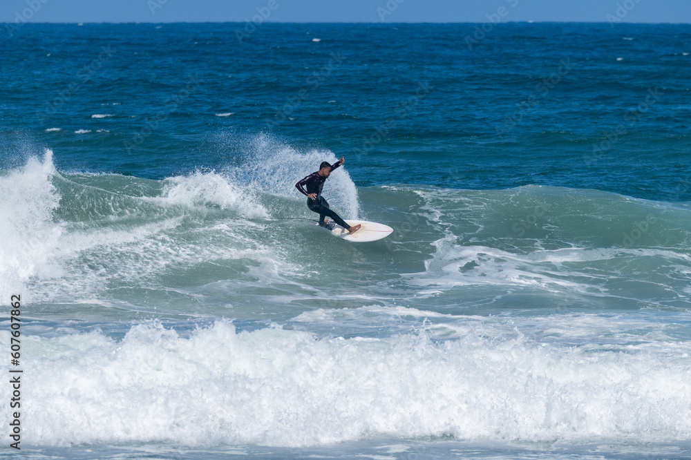 Surfer riding waves in Furadouro Beach Surfer riding waves in Furadouro Beach