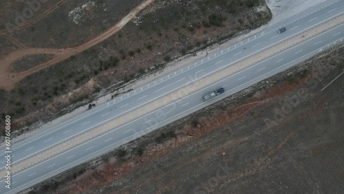 Aerial view of vehicles driving on the road crossing the valley at sunset in Sivrihisar, Eskisehir, Turkey. photo