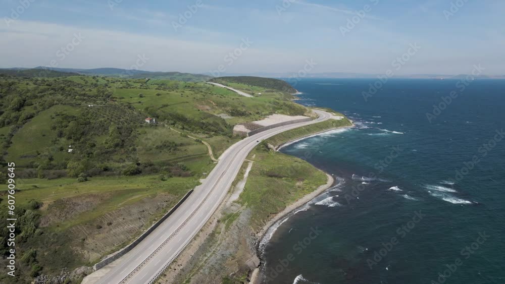 Aerial view of a serpentine road following the coastline along the Marmara Sea, Sevketiye, Lapseki, Turkey. Aerial view of a serpentine road following the coastline along the Marmara Sea, Sevketiye, Lapseki, Turkey.