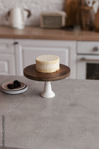 Mini bento cake on a wooden cake bowl. Delicious dessert. The process of decorating a cake with berries photo