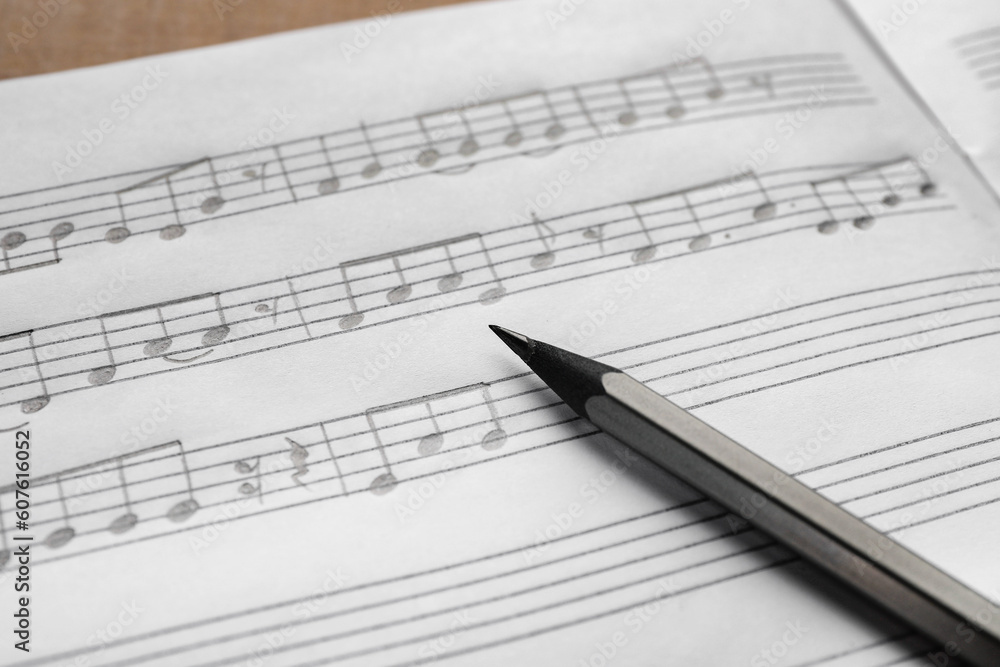 Sheet with musical notes and pencil, closeup view Sheet with musical notes and pencil, closeup view