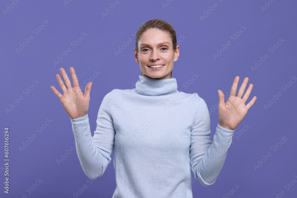 Naklejka premium Woman giving high five with both hands on purple background
