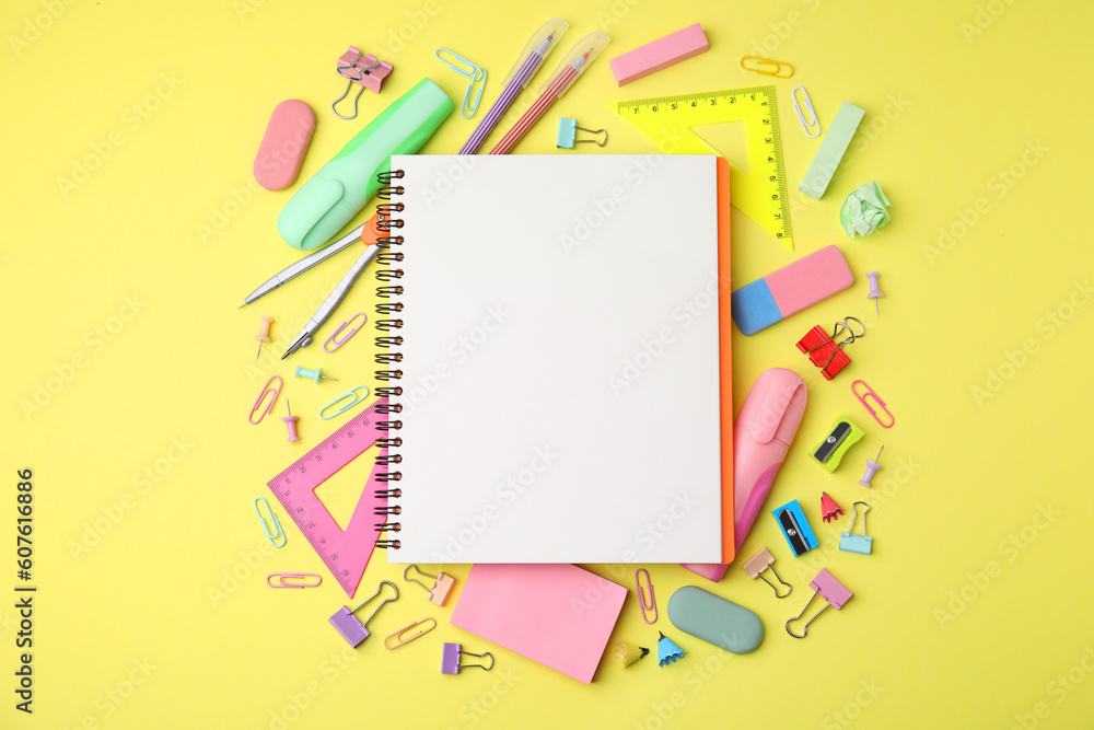 Flat lay composition with notebook and different school stationery on pale yellow background. Back to school Flat lay composition with notebook and different school stationery on pale yellow background. Back to school