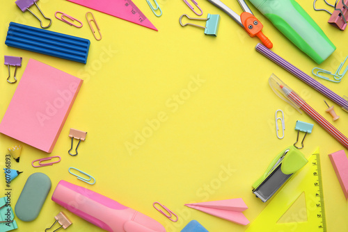 Flat lay composition with different school stationery on pale yellow background, space for text. Back to school