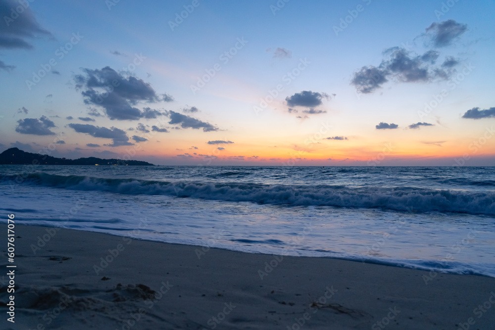 Deserted sandy beach and sea at dawn on a tropical island
