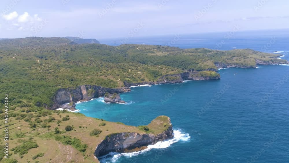 Aerial view of wild coastline with high cliffs in Nusa Penida, Bali island, Indonesia. Aerial view of wild coastline with high cliffs in Nusa Penida, Bali island, Indonesia.