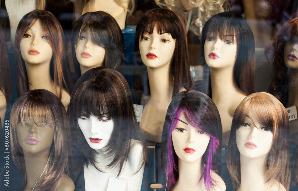 Mannequins wearing wigs in a store. Mannequins wearing wigs in a store.