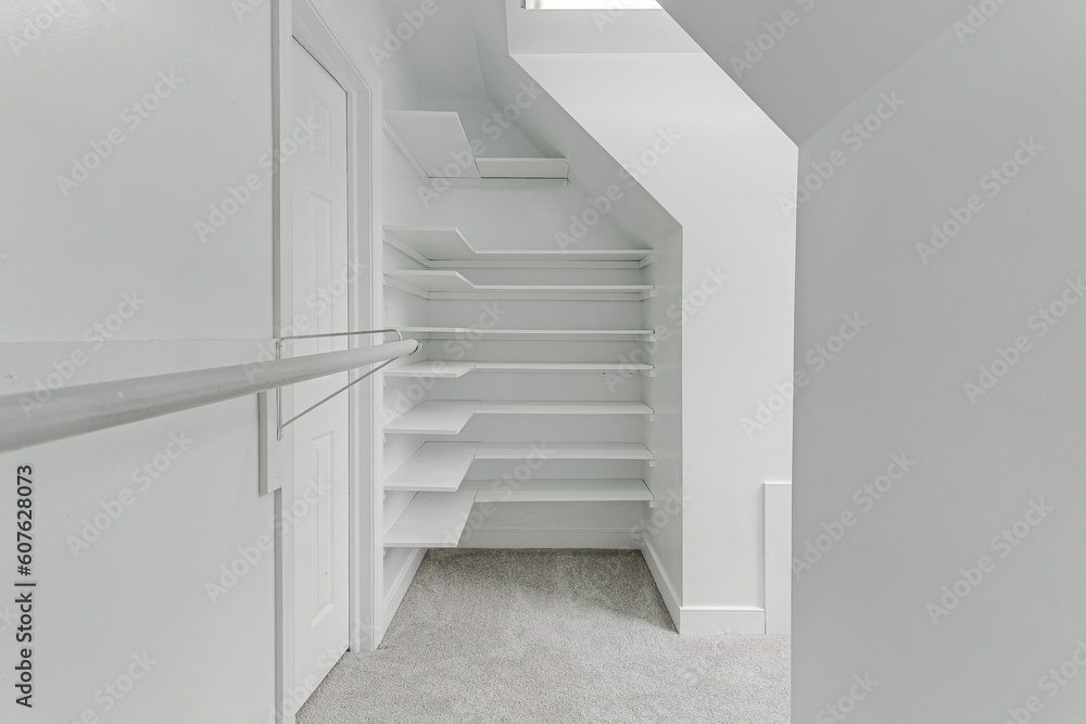 Fototapeta premium Modern Empty Primary Bedroom Closet Interior with Shelves