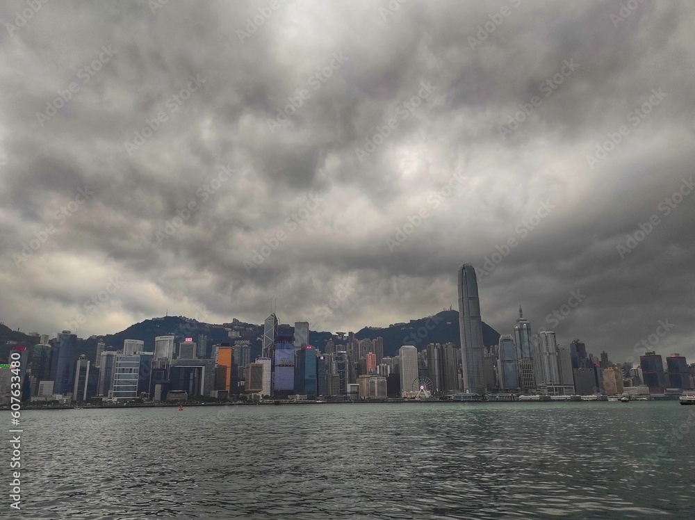 Overcast weather in the afternoon in Victoria harbour, Hong Kong. View from Avenue of Stars, Tsim Sha Tsui.