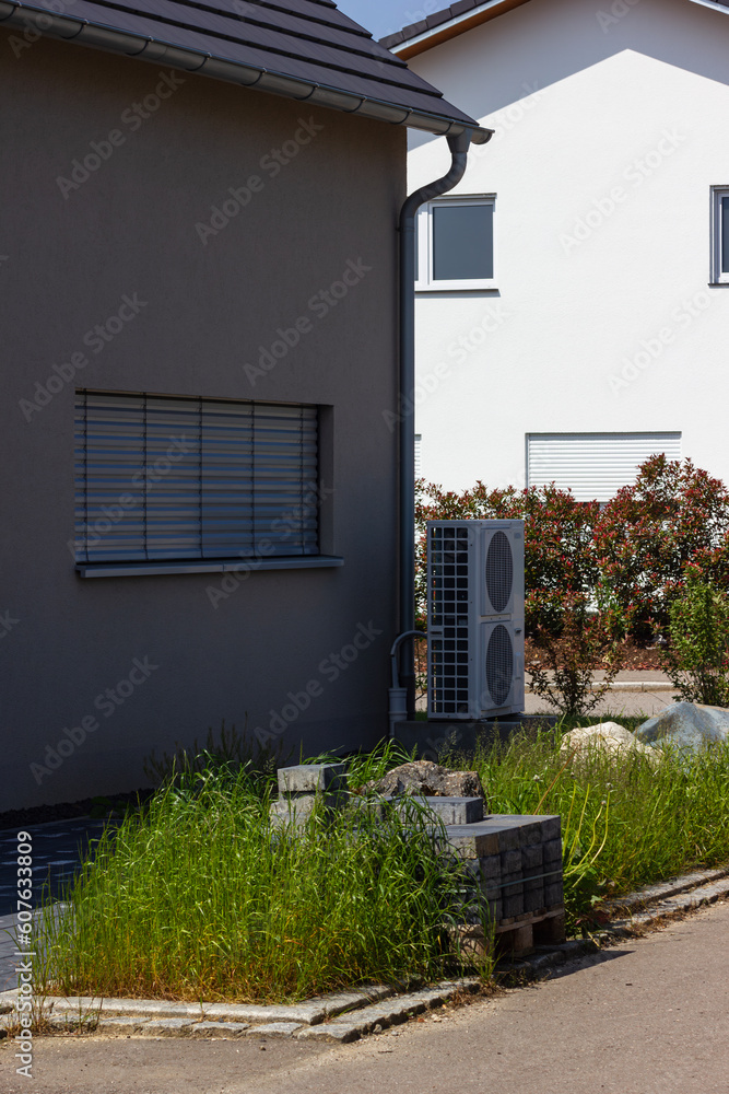 Obraz premium heat pump in a new building area with modern house facades