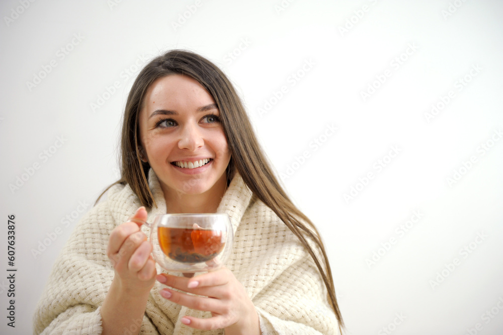 Portrait of joyful young woman enjoying cup of coffee at home. Smiling pretty girl drinking hot tea in winter. Excited woman wearing spectacles and sweater and laughing in an autumn day. High quality Portrait of joyful young woman enjoying cup of coffee at home. Smiling pretty girl drinking hot tea in winter. Excited woman wearing spectacles and sweater and laughing in an autumn day. High quality