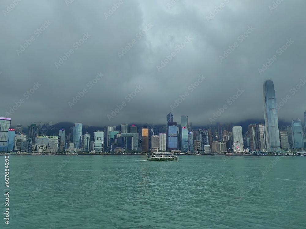 Overcast weather in the afternoon in Victoria harbour, Hong Kong. View from Avenue of Stars, Tsim Sha Tsui. Overcast weather in the afternoon in Victoria harbour, Hong Kong. View from Avenue of Stars, Tsim Sha Tsui.