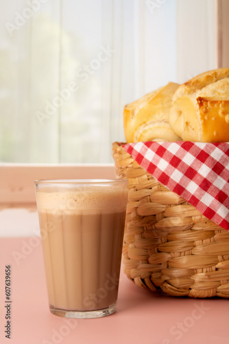 Toasted bread with melted butter, Brazilian breakfast food, coffee and milk, vertical photo