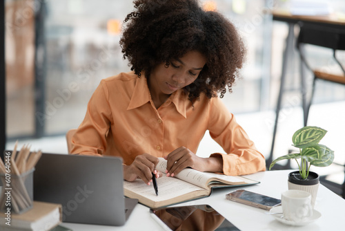 Asian business woman Working at the office, use notebook, smart phone