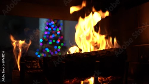 Christmas fire burning with a  lighted  Christmas tree in the background #3 photo