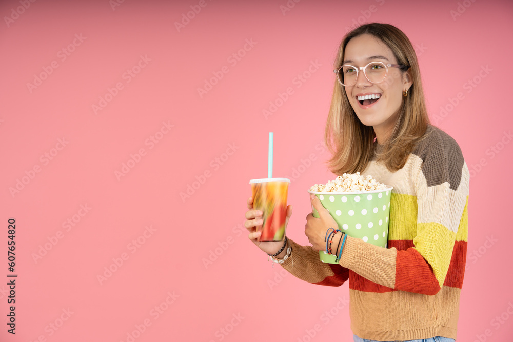 Happy young woman carrying popcorn to go to the movies Happy young woman carrying popcorn to go to the movies