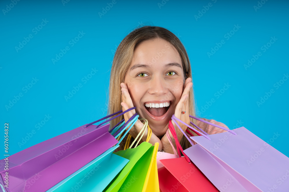Smiling young woman holding gift bags