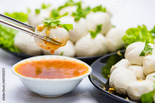 Fish balls ready to be served in a white container.