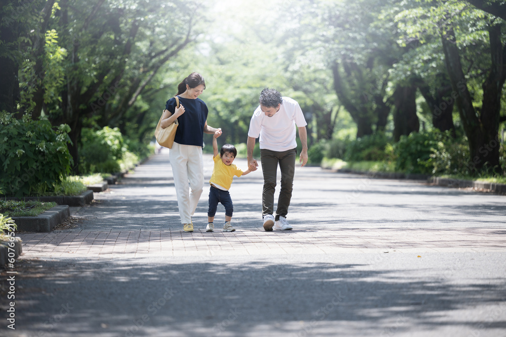 Family going out in the park or outside in the fresh green, holding hands, wide angle Family going out in the park or outside in the fresh green, holding hands, wide angle