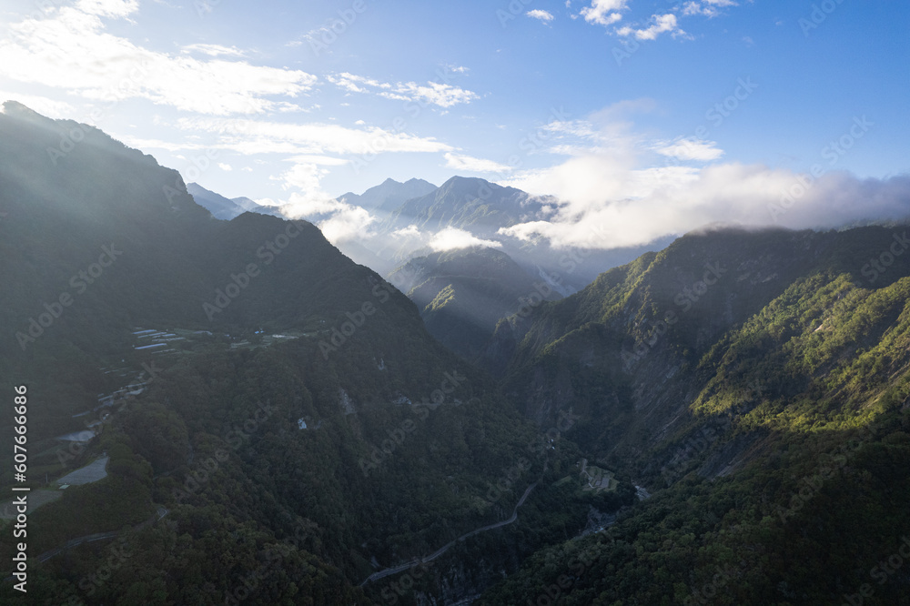 An aerial shot of sun rays cutting through the clouds and gigantic mountains of eastern Taiwan An aerial shot of sun rays cutting through the clouds and gigantic mountains of eastern Taiwan