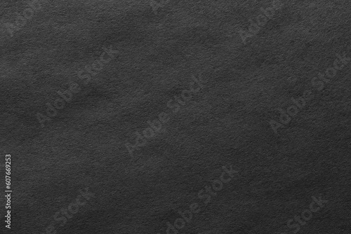 Black paper sheet texture cardboard background.