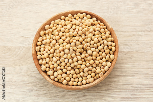 Soybean seeds (kacang kedelai) on wooden plate, food ingredients
