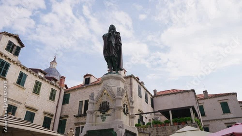 Statue Of Poet Ivan Gundulic Stands At Gundulic Square In Dubrovnik, Croatia. pan shot, low-angle photo