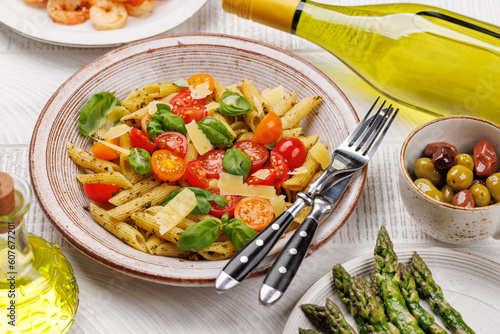 Italian pasta adorned with fresh tomatoes and aromatic basil
