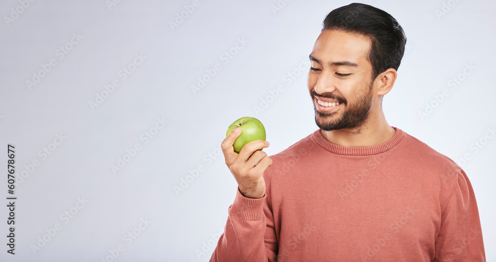Man, apple and nutrition, health and diet, mockup space and eating isolated on studio background. Male person with smile, green fruit and organic with healthy food, vegan with detox and lose weight Man, apple and nutrition, health and diet, mockup space and eating isolated on studio background. Male person with smile, green fruit and organic with healthy food, vegan with detox and lose weight